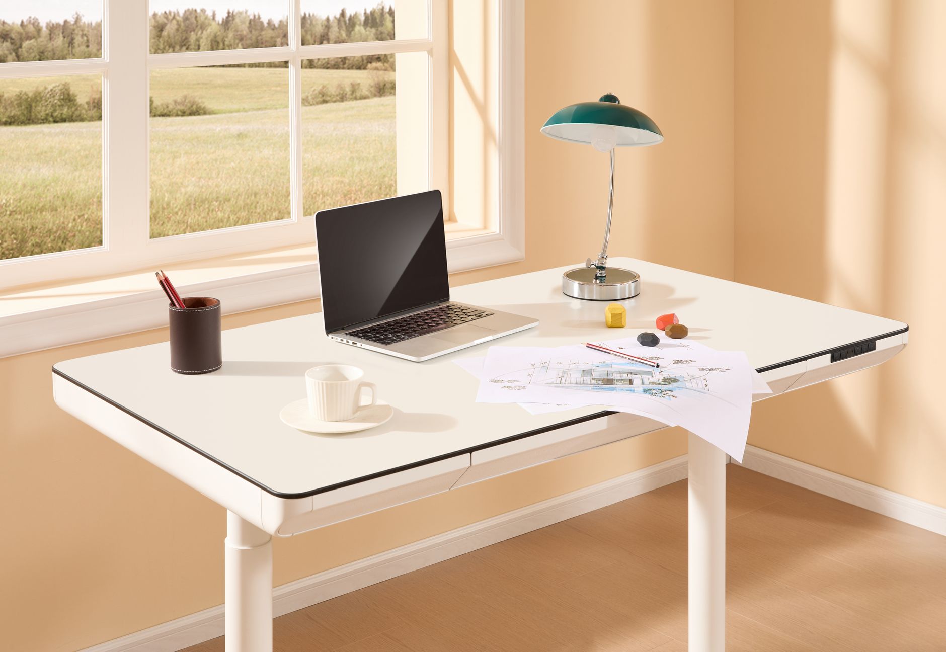 White autonomous standing desk with black frame in a bright home office