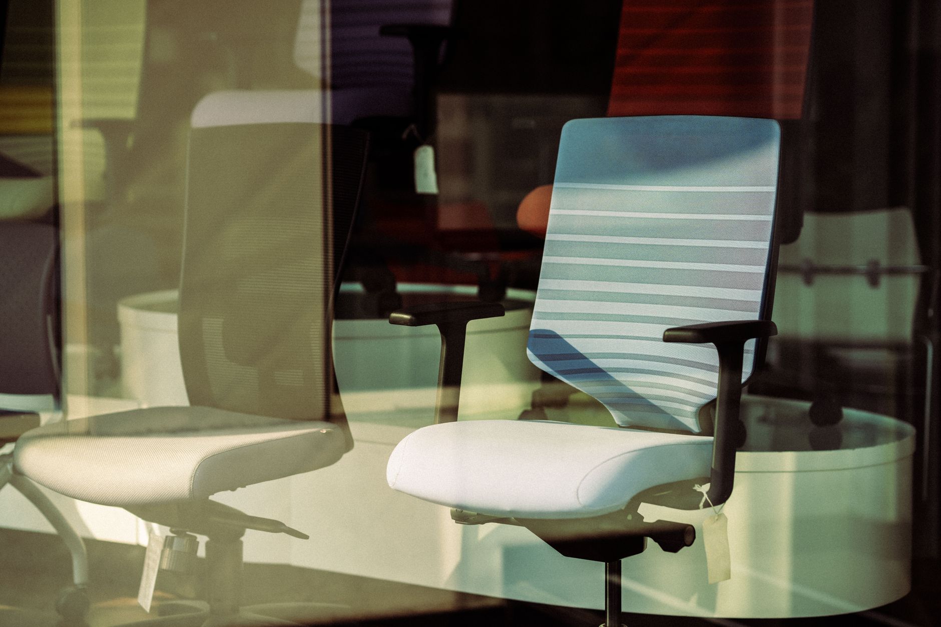 Black mesh ergonomic office chair with adjustable lumbar support at a desk