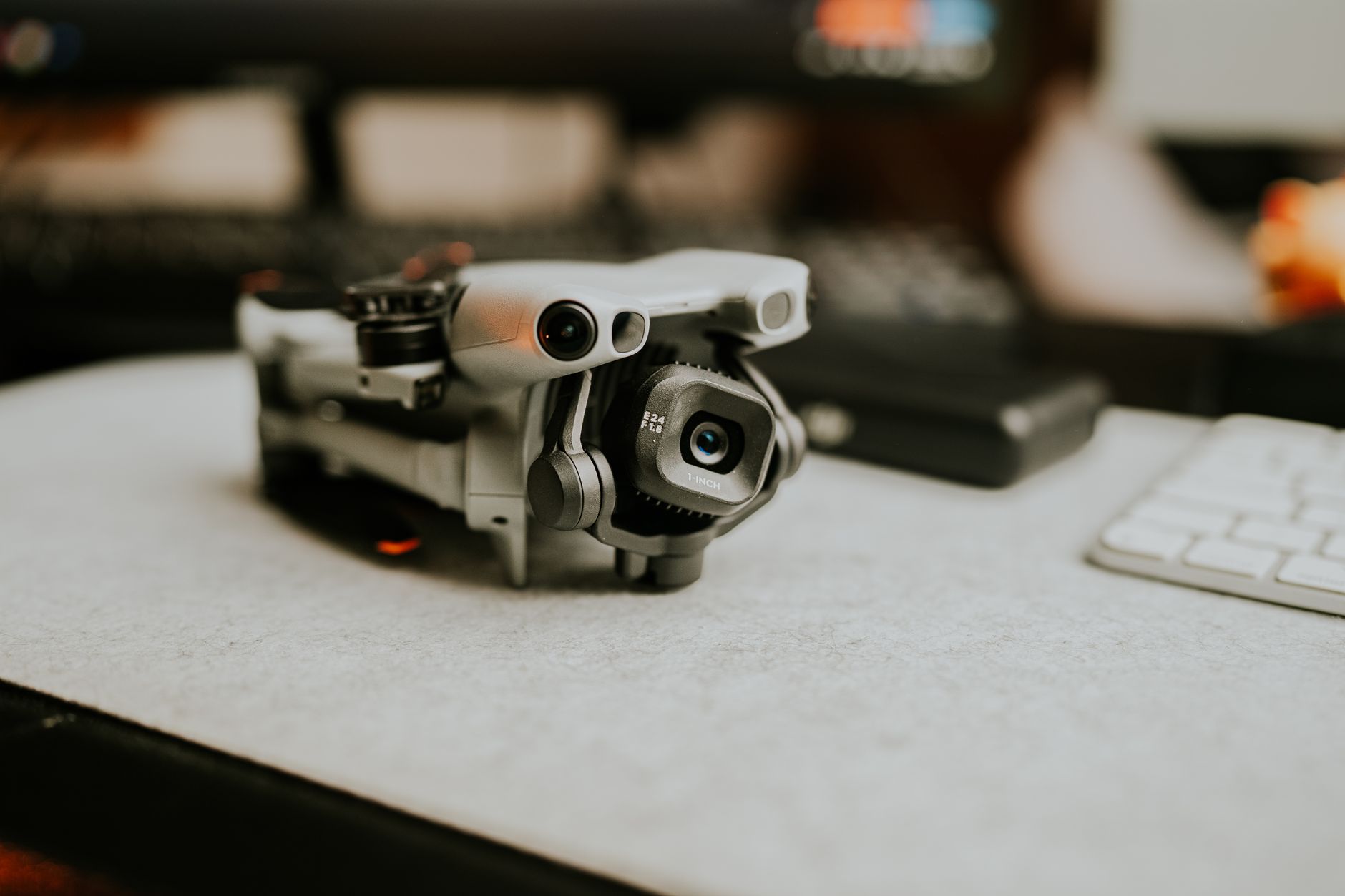 Insta360 Link 2 webcam mounted beside a home office display