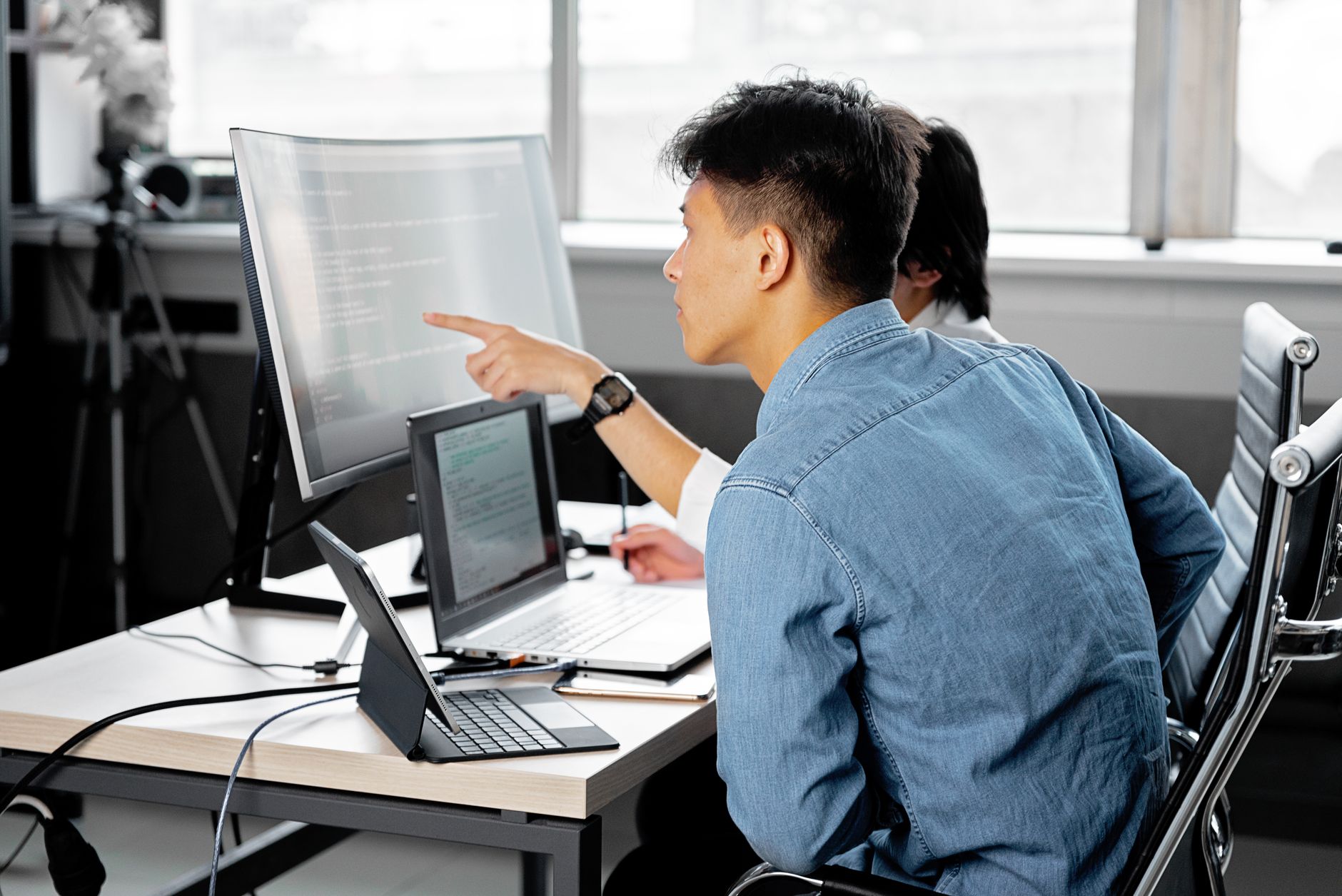 a person checking workstation setup with a laptop and external monitor in a home office